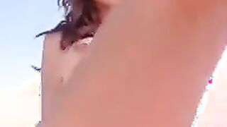 Naked brunette at the beach shows her skills for mastur